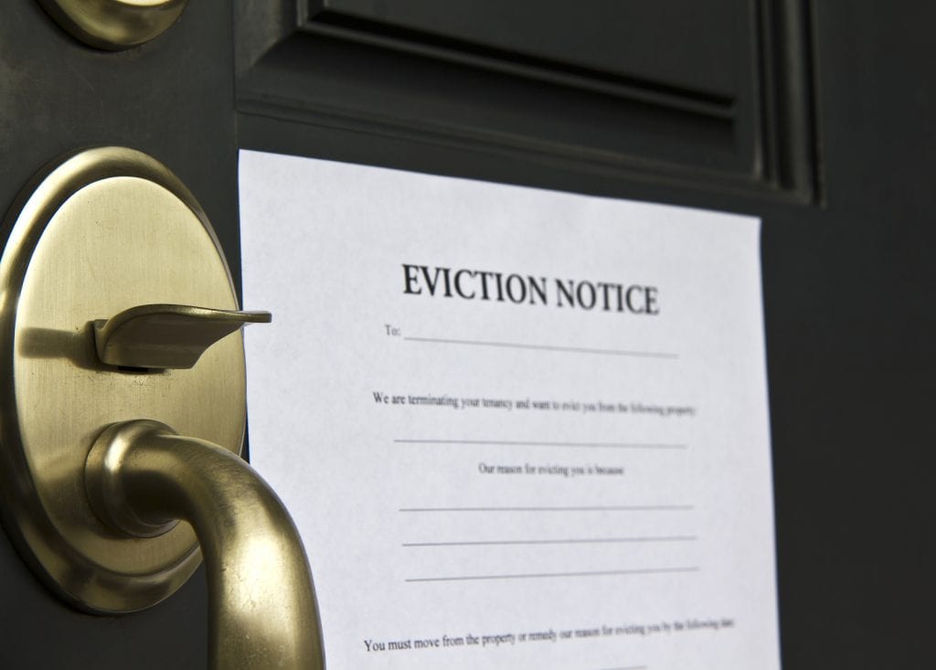 Image of an eviction notice attached to a door, in the blog 3 Steps to Legal Evictions.