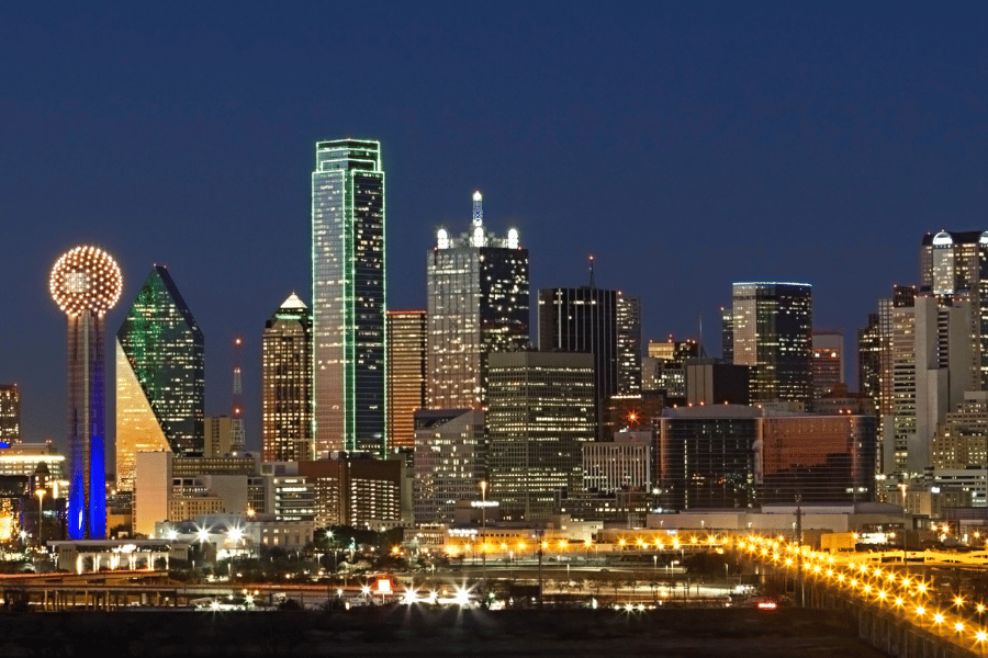 Rental property management in DFW will look different in 2024; blog post image depicting Dallas skyline at night.